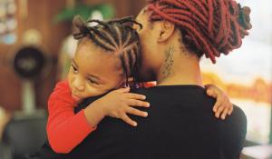 A Black mother and daughter embrace. Photo via Stocksy.